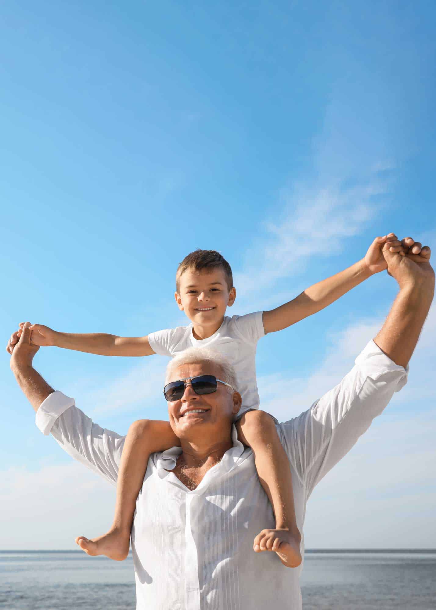 man with kid on his shoulders